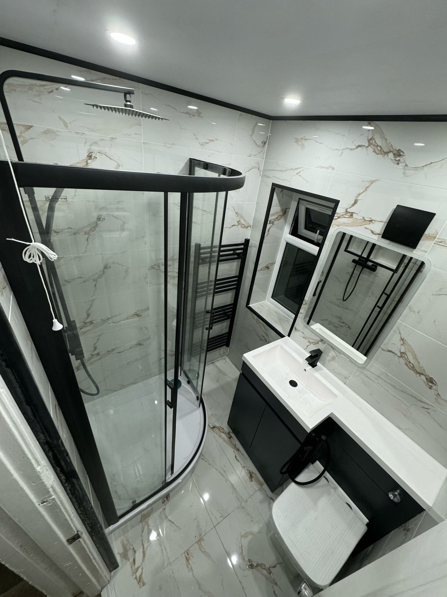 Completed bathroom refurbishment with walk-in shower