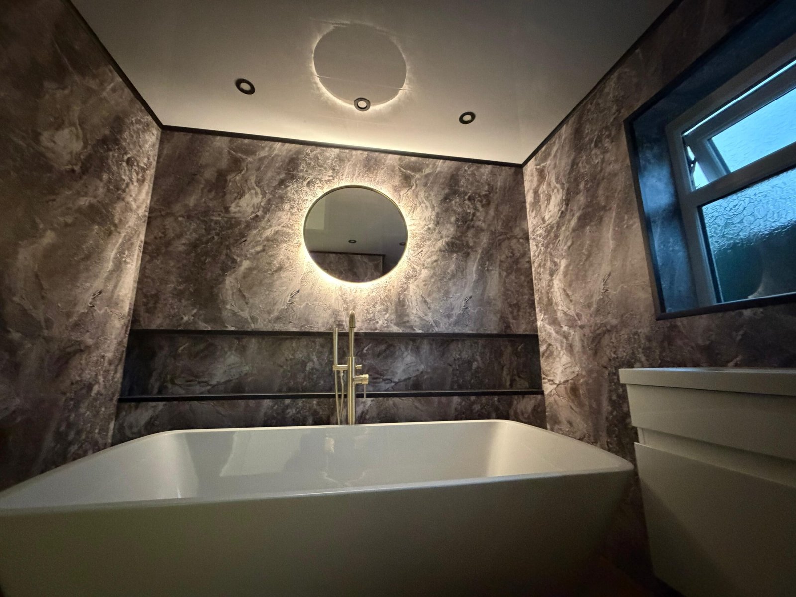 Premium bathroom renovation with modern fixtures and lighting